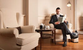 Young businessman relaxing reading a book