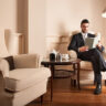 Young businessman relaxing reading a book