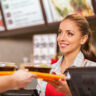 Restaurant worker serving two fast food meals