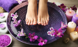 Female feet at spa pedicure procedure